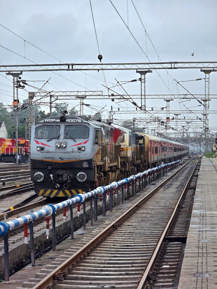 Electric locomotive at Ambala Cantt railway station in India, showcasing intricate rail network.